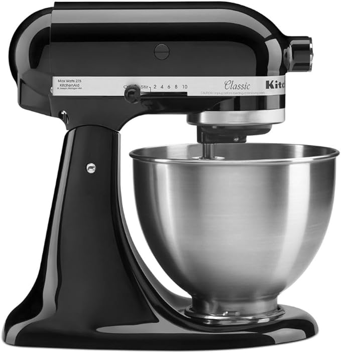 A black mixer with a metal bowl on top of it.