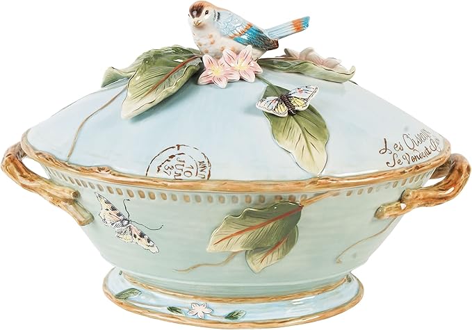 A blue bowl with a bird on top of it.