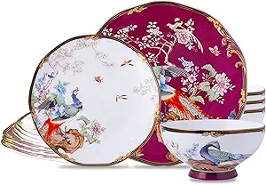 A set of dishes with birds and flowers on them.