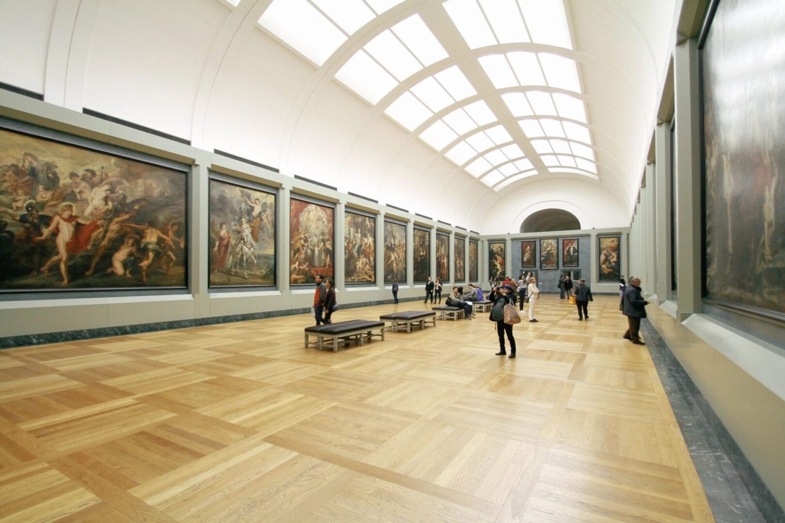 A large room with many paintings on the walls.