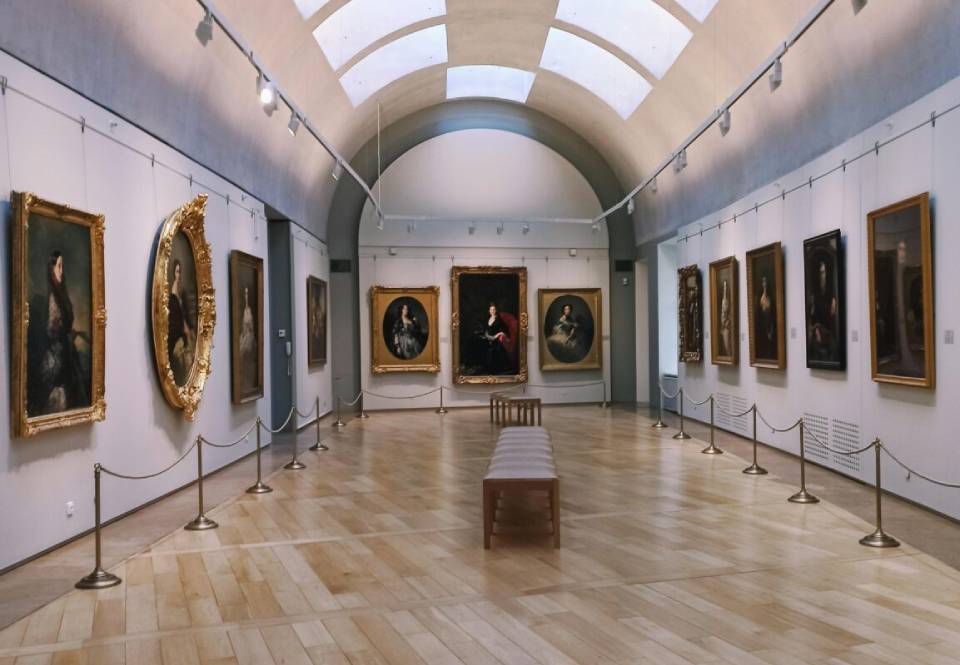 A room filled with lots of paintings on the walls.