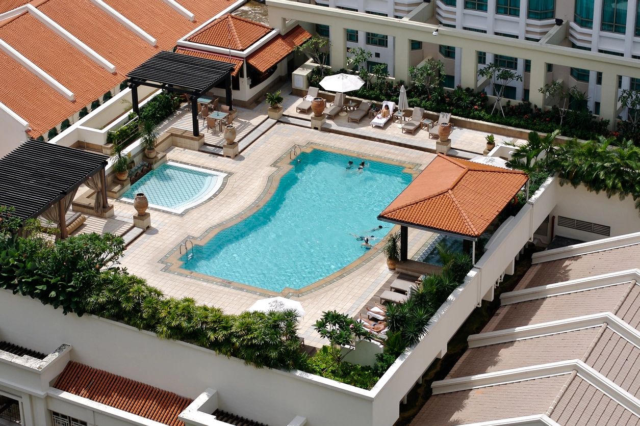 A pool with a jacuzzi and a swimming area