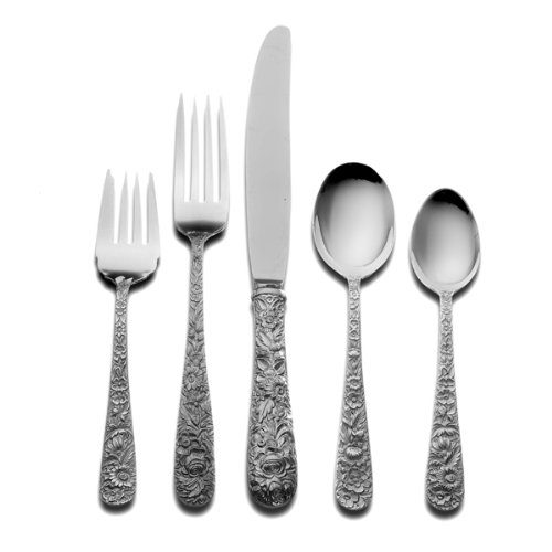 A set of silverware with floral design on the handle.