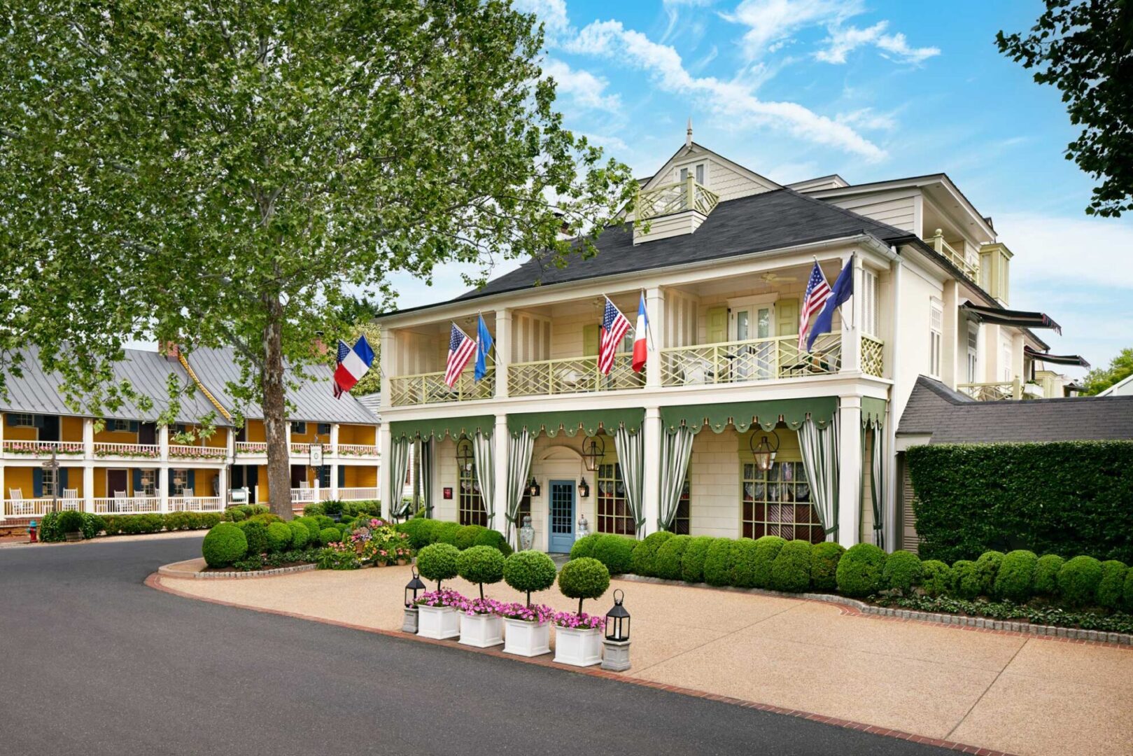 A large white building with flags on the front.