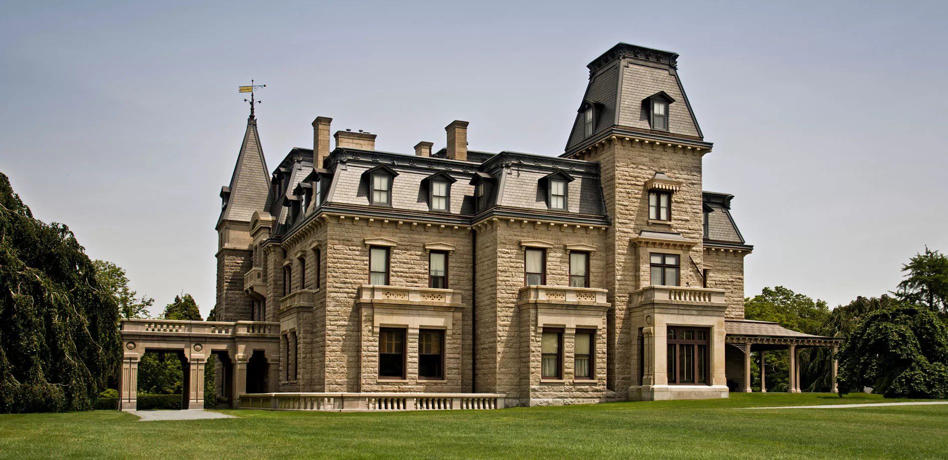 A large stone building with many windows and a tower.