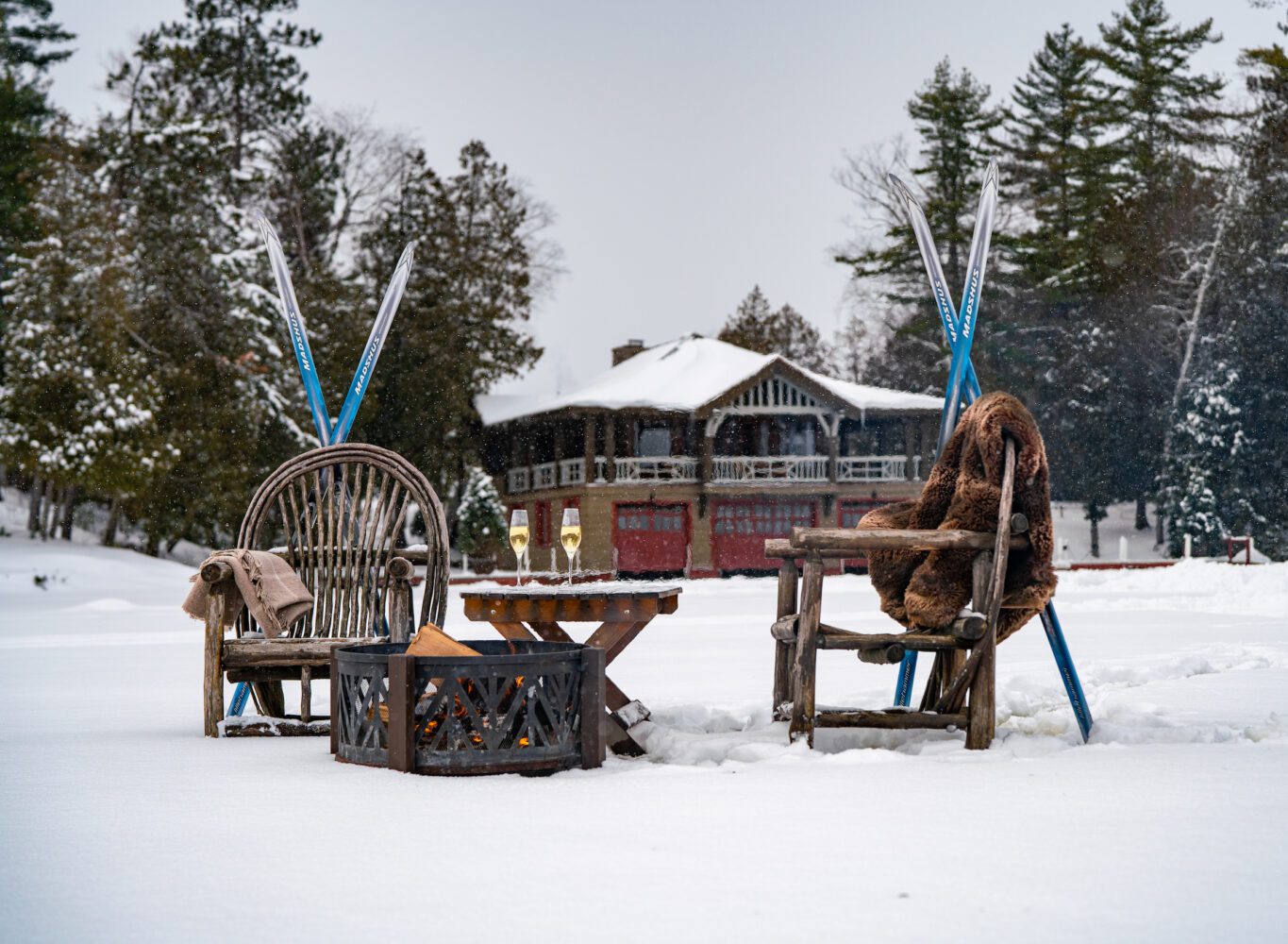 A group of chairs and tables in the snow.