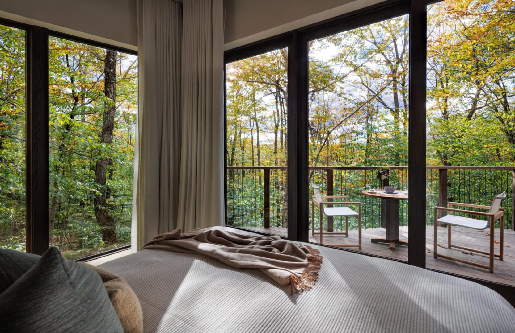 A bedroom with a view of the trees