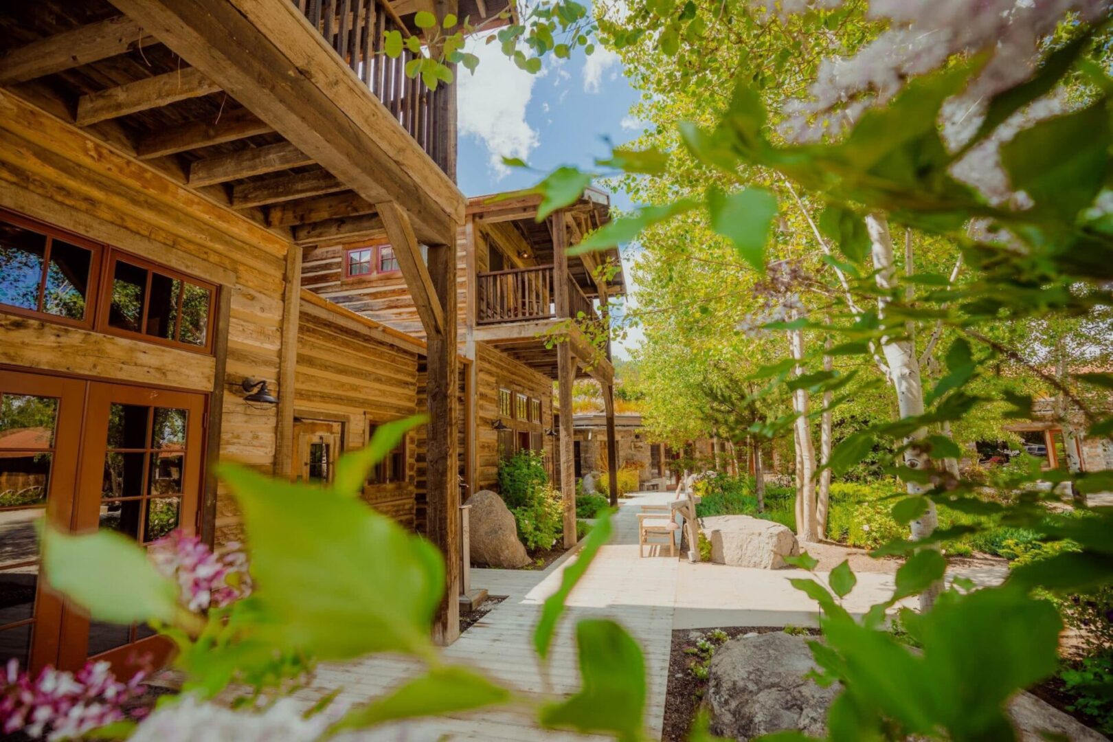 A wooden building with many trees in the background