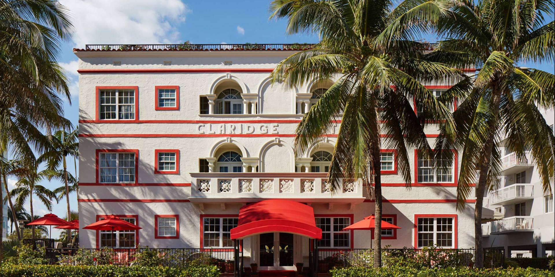 A red umbrella is in front of the building.