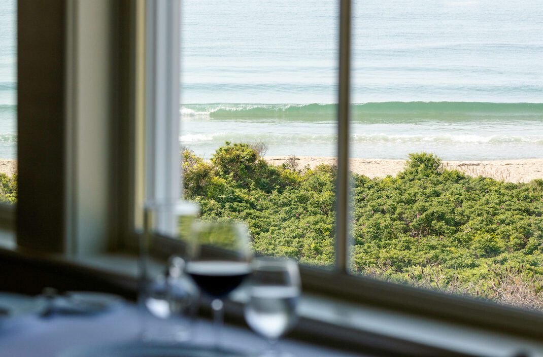 A view of the ocean from a window.