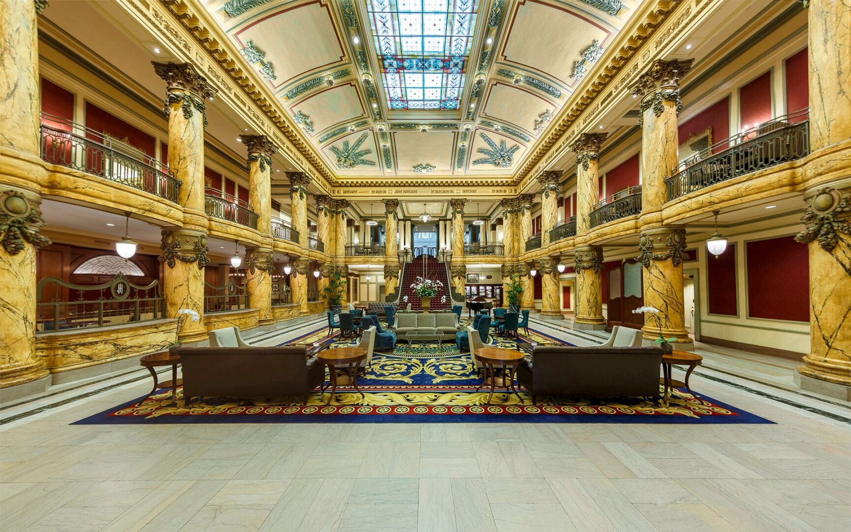 A large lobby with many couches and tables.