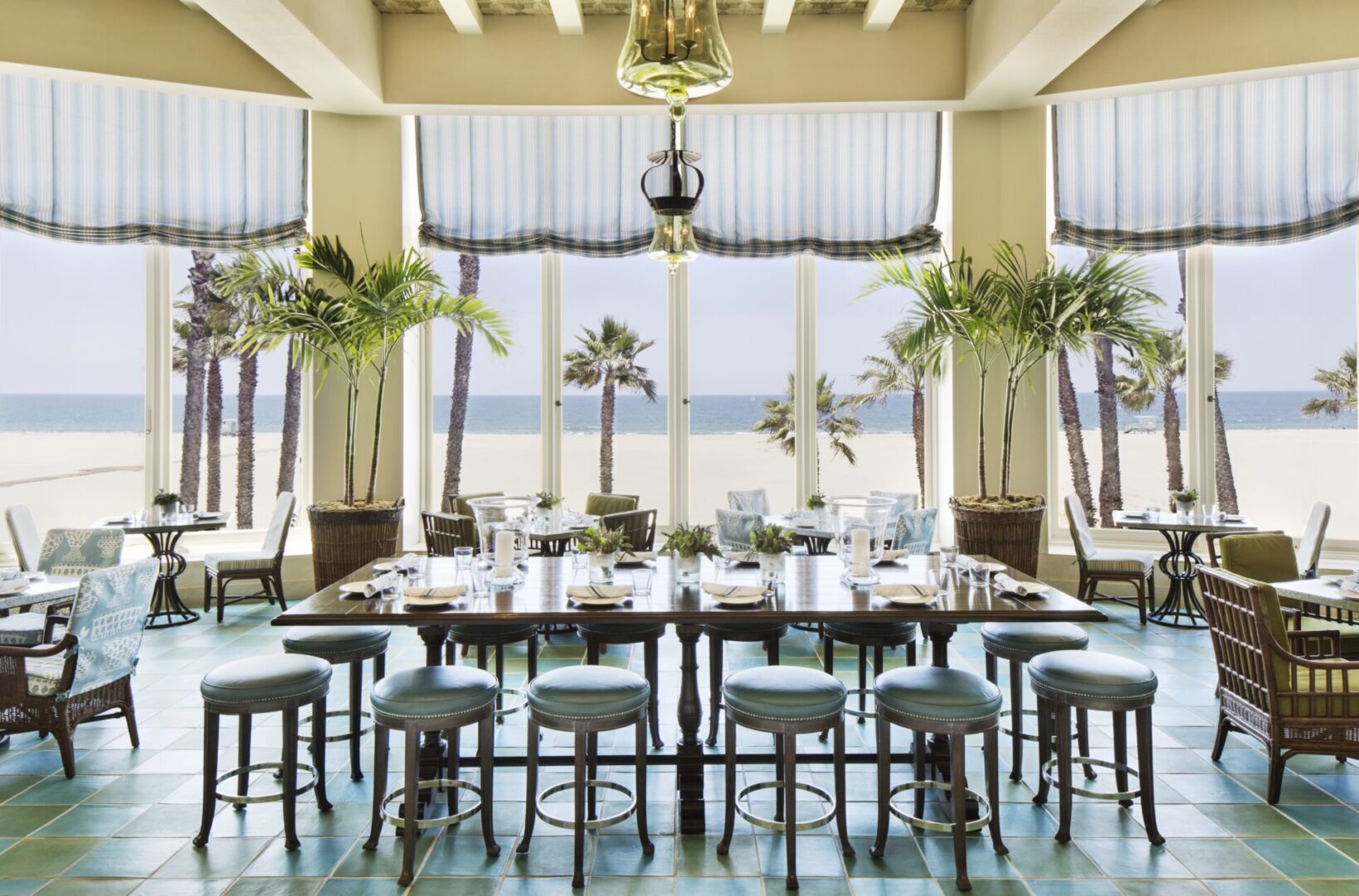 A large dining room with a view of the ocean.