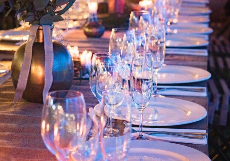 A long table with plates and wine glasses on it